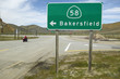 Photo: A motorcycle driving past a road sign pointing to Route 58 near Bakersfield CA A motorcycle driving past a road sign pointing to Route 58 near Bakersfield CA