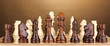Chess board with chess pieces on brown background
