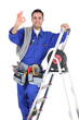 young electrician in studio looking happy