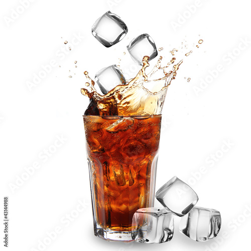 Photo: Cola glass with falling ice cubes over white Cola glass with falling ice cubes over white