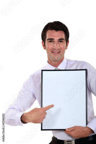Photo: Man holding up a blank bulletin board Man holding up a blank bulletin board