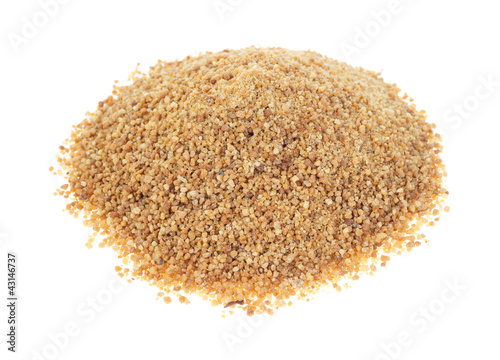 Photo: Coconut palm sugar on white background Coconut palm sugar on white background