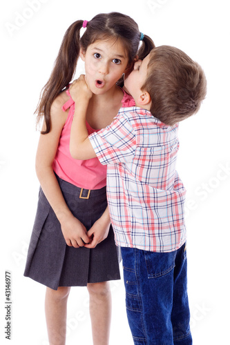 Photo: Little boy whispering something to girl Little boy whispering something to girl