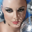 Photo: Young woman holding disco ball Young woman holding disco ball