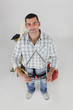 Man holding house shaped measuring device