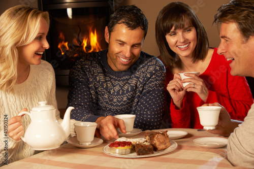 Photo: Group Of Middle Aged Couples Enjoying Tea And Cake Together Group Of Middle Aged Couples Enjoying Tea And Cake Together