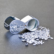 Photo: Loose diamonds next to a 10x magnifier glass Loose diamonds next to a 10x magnifier glass