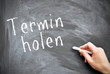 Termin holen auf Tafel geschrieben