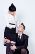 modern young business couple posing on gray background