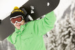 Teenage Boy With Snowboard On Ski Holiday In Mountains