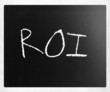 The word "ROI" handwritten with white chalk on a blackboard