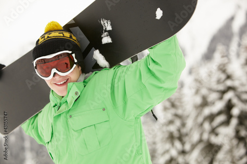 Photo: Teenage Boy With Snowboard On Ski Holiday In Mountains Teenage Boy With Snowboard On Ski Holiday In Mountains