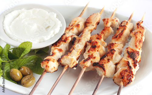Photo: Shish taouk - Chicken shish kebab on white platter Shish taouk - Chicken shish kebab on white platter