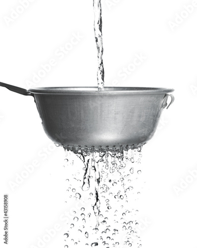 Photo: Water poured through a strainer Water poured through a strainer