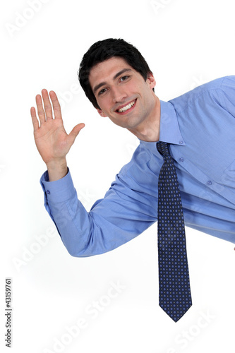 Photo: A businessman waving. A businessman waving.