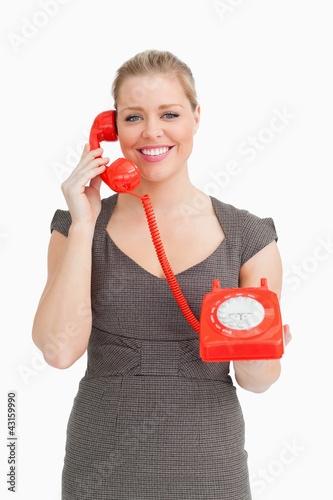 Photo: Woman calling with a dial phone Woman calling with a dial phone