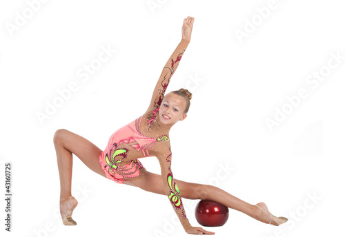 Photo: gymnast performs an exercise with a ball gymnast performs an exercise with a ball