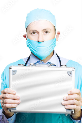 Photo: Doctor holding a metal first aid kit Doctor holding a metal first aid kit