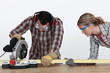 Couple sawing timber