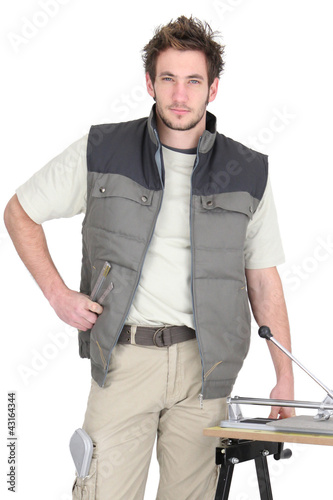 Photo: Professional tile fitter with his building materials and tools Professional tile fitter with his building materials and tools