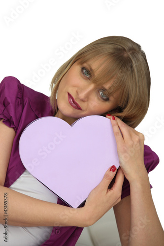 Photo: Woman holding heart-shaped box Woman holding heart-shaped box