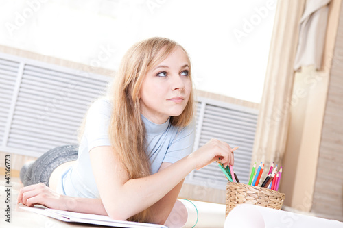 Photo: teenage girl lying on floor drawing teenage girl lying on floor drawing