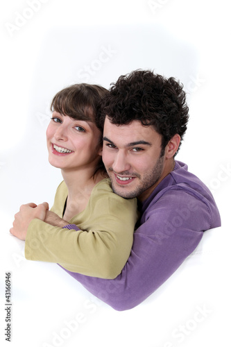 Photo: A loving young couple cuddling A loving young couple cuddling