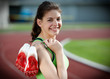 Young female sprinter standing on a running track