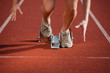 female sprinter leaving the starting blocks on a track