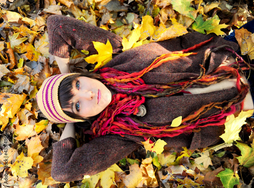 Photo: Girl lying in leaves. Girl lying in leaves.