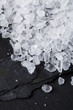Coarse sea salt on black slate stone background, closeup