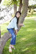 Photo: Young girl resting on a tree branch Young girl resting on a tree branch