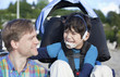 Photo: Father enjoying beach with disabled son Father enjoying beach with disabled son