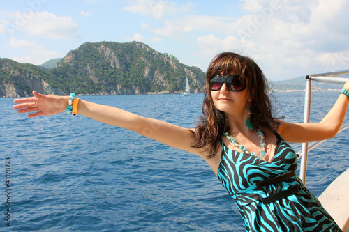 Photo: Happy young woman on yacht in the sea Happy young woman on yacht in the sea