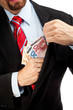 Businessman putting money in his pocket.