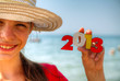 Teen girl holding wooden number '2013'