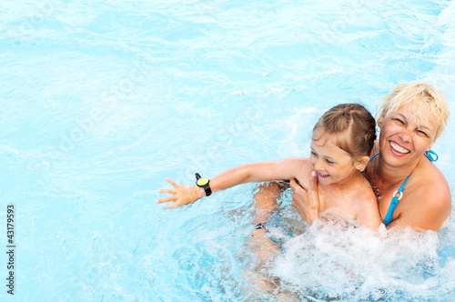 Photo: woman and little girl swimming woman and little girl swimming