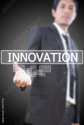 Photo: Businessman holding Innovation word on the whiteboard. Businessman holding Innovation word on the whiteboard.