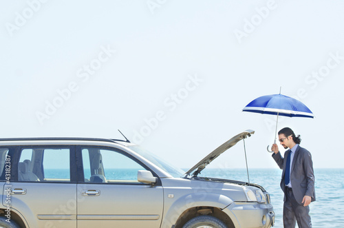 Photo: Man with car on seaside Man with car on seaside