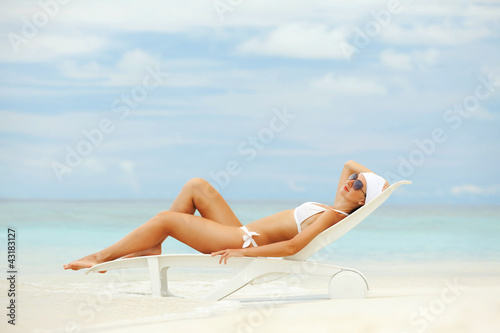 Photo: Happy fashion woman rest on the beach Happy fashion woman rest on the beach