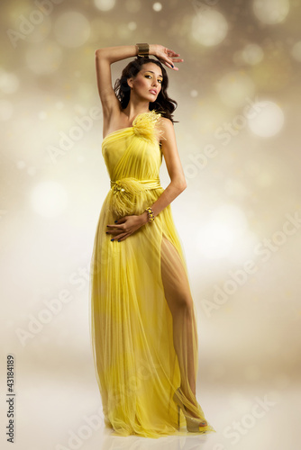 Photo: beautiful woman in yellow evening dress beautiful woman in yellow evening dress
