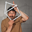 man with folding rule in the shape of a house