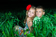 group of happy children playing on meadow, sunset, summertime