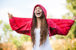 Woman in raincoat enjoying the rain