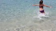 beautiful little girl playing in ibiza beach on vacation