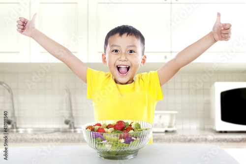 Photo: Pleased child with salad Pleased child with salad