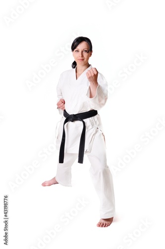 Photo: Karate woman posing on a white background Karate woman posing on a white background