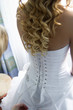 Unfinished stay-lace on bride's dress