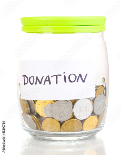 Foto: Glass bank for tips with money isolated on white Glass bank for tips with money isolated on white