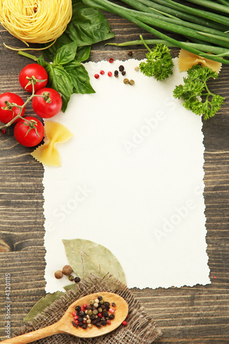 Photo: paper for recipes vegetables, and spices on wooden table paper for recipes vegetables, and spices on wooden table